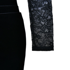 Detail of elegant black lace floral sleeve and luxury velvet bodice texture of the dress