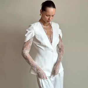 Elegant off-white women's suit with deep V-neck lace detailing and wide-leg trousers