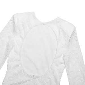 Close-up of white lace dress featuring an oval open back and elegant pearl button closure
