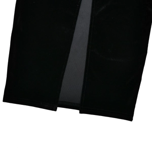 Detailed close-up of a high-quality black velvet dress hem showing a center slit detail