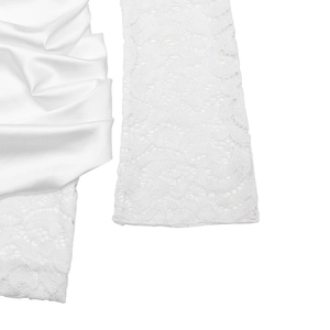 Close-up of white jacquard lace and satin fabric textures on this bodycon dress