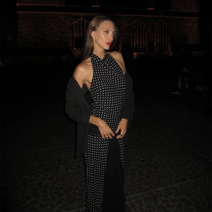 Polka dot halter maxi dress with black blazer outer layer in night street setting