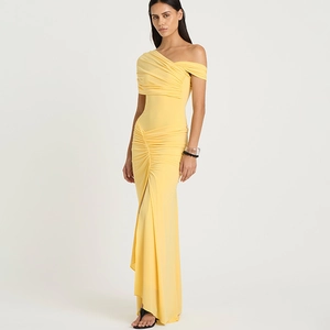 Detail view of yellow one-shoulder ruched dress with slim fit and elegant draping