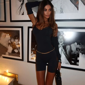 Detail of slim fit black bodysuit with lace neckline, fingerless gloves and gold chain belt