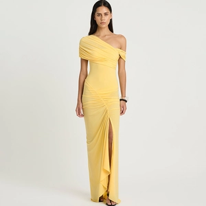 Detail of ruched pale yellow off-shoulder long dress with high slit and draping texture