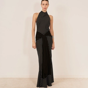 Detailed view of polka dot halter dress featuring a large waist bow and backless design