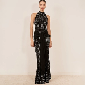 Detailed view of polka dot halter dress featuring high waist tie and slim fit silhouette