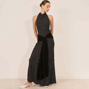 Detail of polka dot halter maxi dress showing high waist ribbon tie and flowing fabric