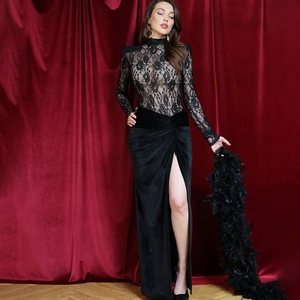 Detail of sheer lace bodice and high-slit velvet skirt on a formal evening dress