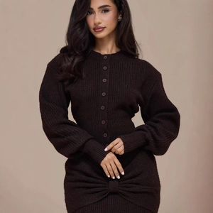 Detail of chocolate knit dress showing single-breasted buttons and front twist bow knot