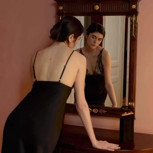 Sultry black satin slip dress with lace bodice detail and open back design