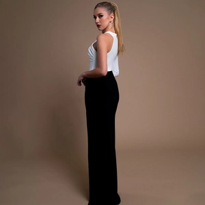 Elegant one-shoulder white pleated top and high-waist black wide-leg trousers set