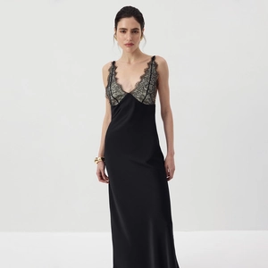 Detailed view of elegant black satin long dress featuring delicate lace trim on V-neckline