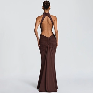 Detail of elegant backless dark brown fishtail gown with ruching and halter neck style