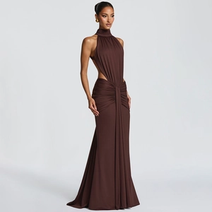 Detail of ruched waist design and side cut-outs on a brown halter neck maxi dress