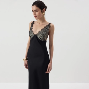 Detail of V-neck lace patchwork on black satin bodycon dress with elegant silk texture