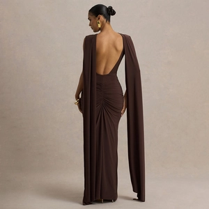 Detail of dark brown backless dress with long cape sleeves and ruched back design