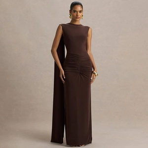 Detail of dark brown slim fit gown featuring elegant pleated waist and long cape element