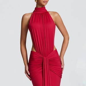 Detail of red halter dress featuring waist cutout and elegant side pleated draping