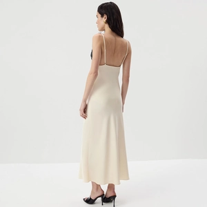 Detail of elegant backless cream satin dress with delicate black lace trim and silk texture