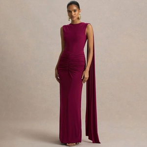 Detail view of burgundy fitted dress featuring pleated waist and long shoulder streamers