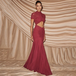 Close-up of wine red evening dress with waist cut-out and elegant ruched details