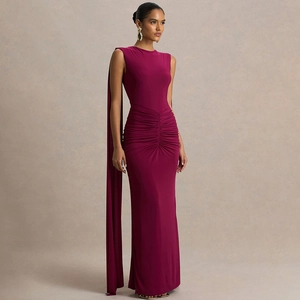 Detail of elegant plum sleeveless gown featuring intricate waist pleats and a matching cape