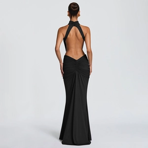 Detail of elegant black halter backless maxi dress with pleated waist and mermaid hemline