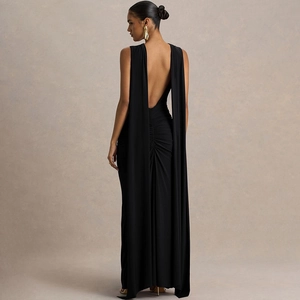 Detail of elegant backless black gown featuring deep U-shape design and long shoulder streamers