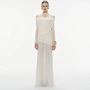 Close-up of elegant white off-shoulder maxi dress with ruched details and sheer long sleeves