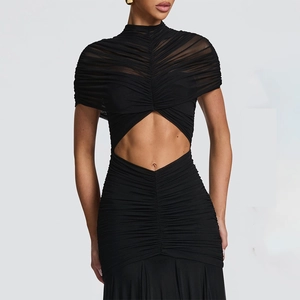 Detail view of the elegant black ruched mesh fabric and waist cut-out on the maxi dress