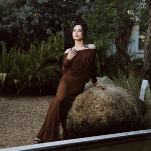 Elegant deep brown off-the-shoulder pleated maxi dress with slim fit and long sleeves