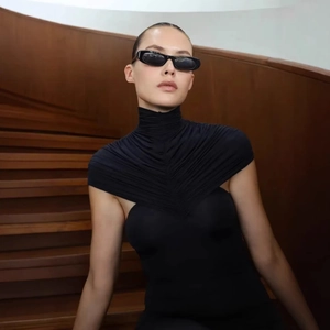Close-up of the elegant pleated high neck detail on a slim-fit black sleeveless dress