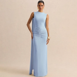 Detail of light blue backless evening gown featuring elegant waist pleats and a long cape