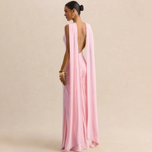 Detail of elegant pink backless gown featuring a draped cape and ruched pleats