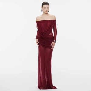 Detail of the draped mesh texture and elegant ruched bodice of a burgundy formal dress