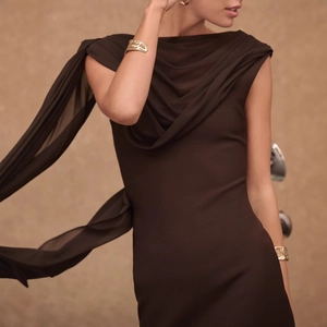 Detail of coffee brown sleeveless dress with cowl neck and flowing elegant streamers