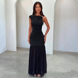 Detail of the elegant one-shoulder black evening gown with a golden ring on the strap