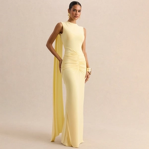 Detail of pale yellow sleeveless evening gown with waist draping and elegant shoulder cape