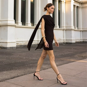 Detail of elegant chocolate brown sleeveless mini dress with draped sash and backless design