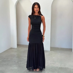 Detail of elegant black pleated evening gown with gold shoulder clasp and chiffon mermaid hem