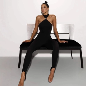 Detail of black halter catsuit featuring silver metal buckle and stirrup leggings design