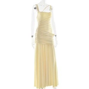 Detail of elegant pale yellow ruched evening dress with thin straps and slim fit design