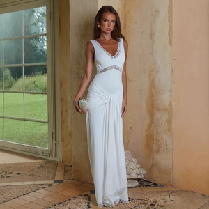 Close-up of elegant white lace splicing and ruched waist detail on a sleeveless V-neck dress