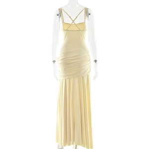 Detail of cross-back straps and elegant pleated texture on a cream sleeveless maxi dress