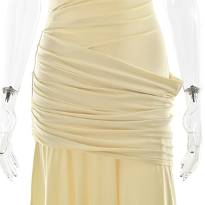 Detail of elegant cream pleated dress showing delicate ruching and fabric texture