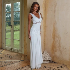 Detail of elegant white V-neck dress featuring delicate lace stitching and ruched waist fabric