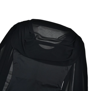 Detail of elegant cowl neckline design featuring sheer mesh and pleated black fabric textures