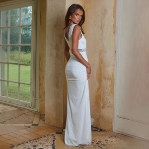 Detailed back view of white lace patchwork sleeveless ruched evening dress on model