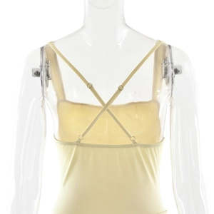 Detail of adjustable criss-cross straps and metallic buckles on back of yellow midi dress